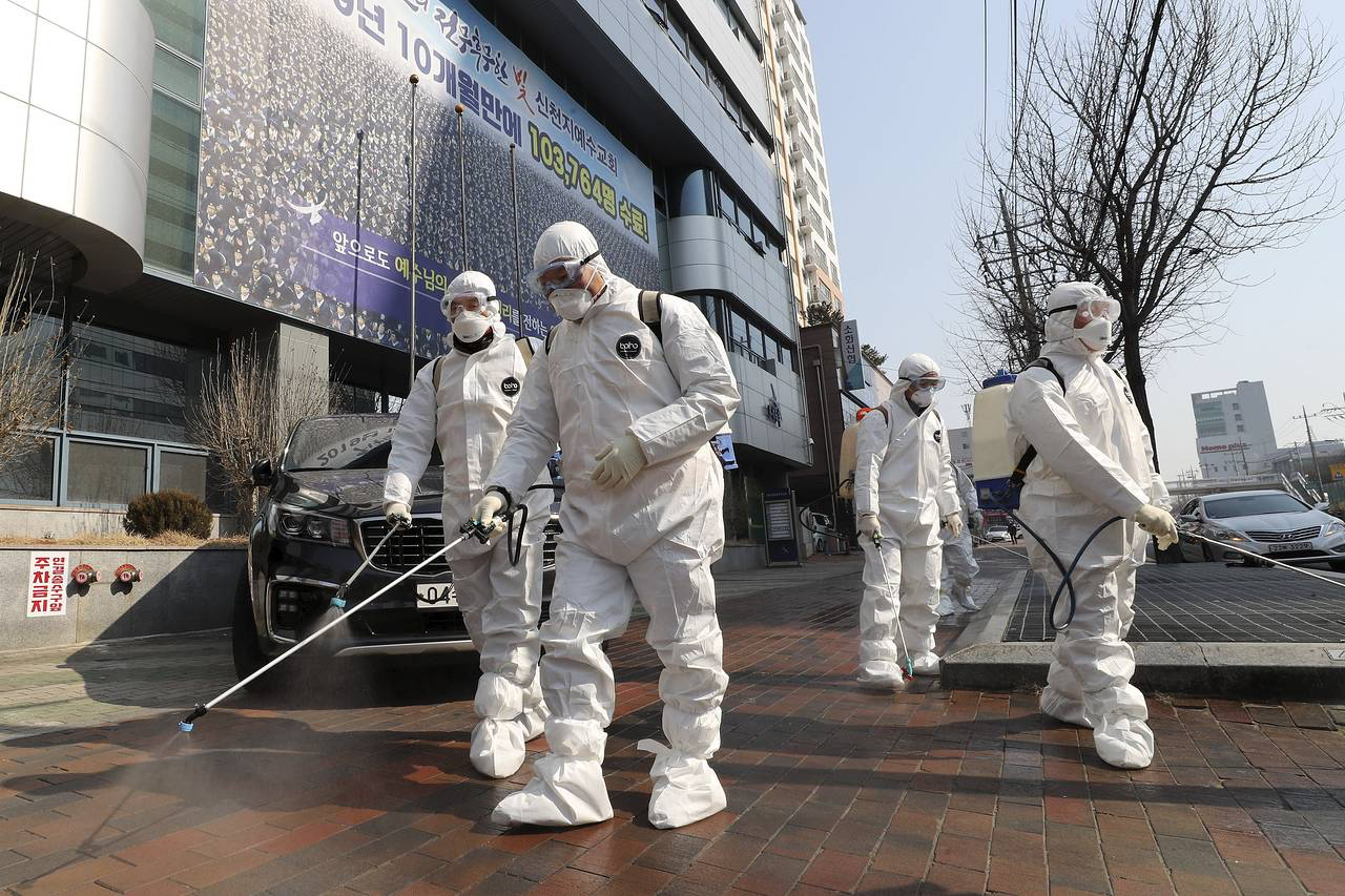 Workers wearing protective gear in South Korea.ASSOCIATED PRESS