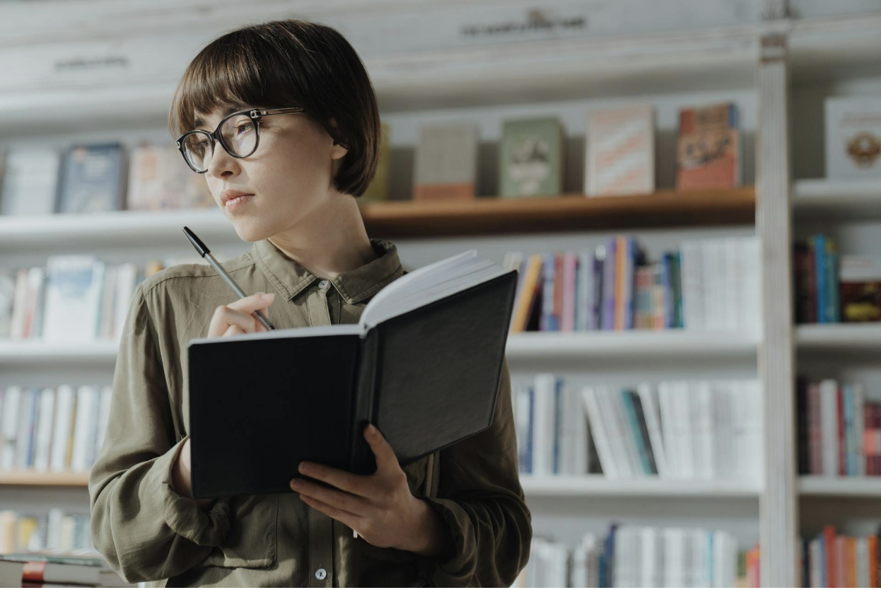 woman taking notes in a bookstore